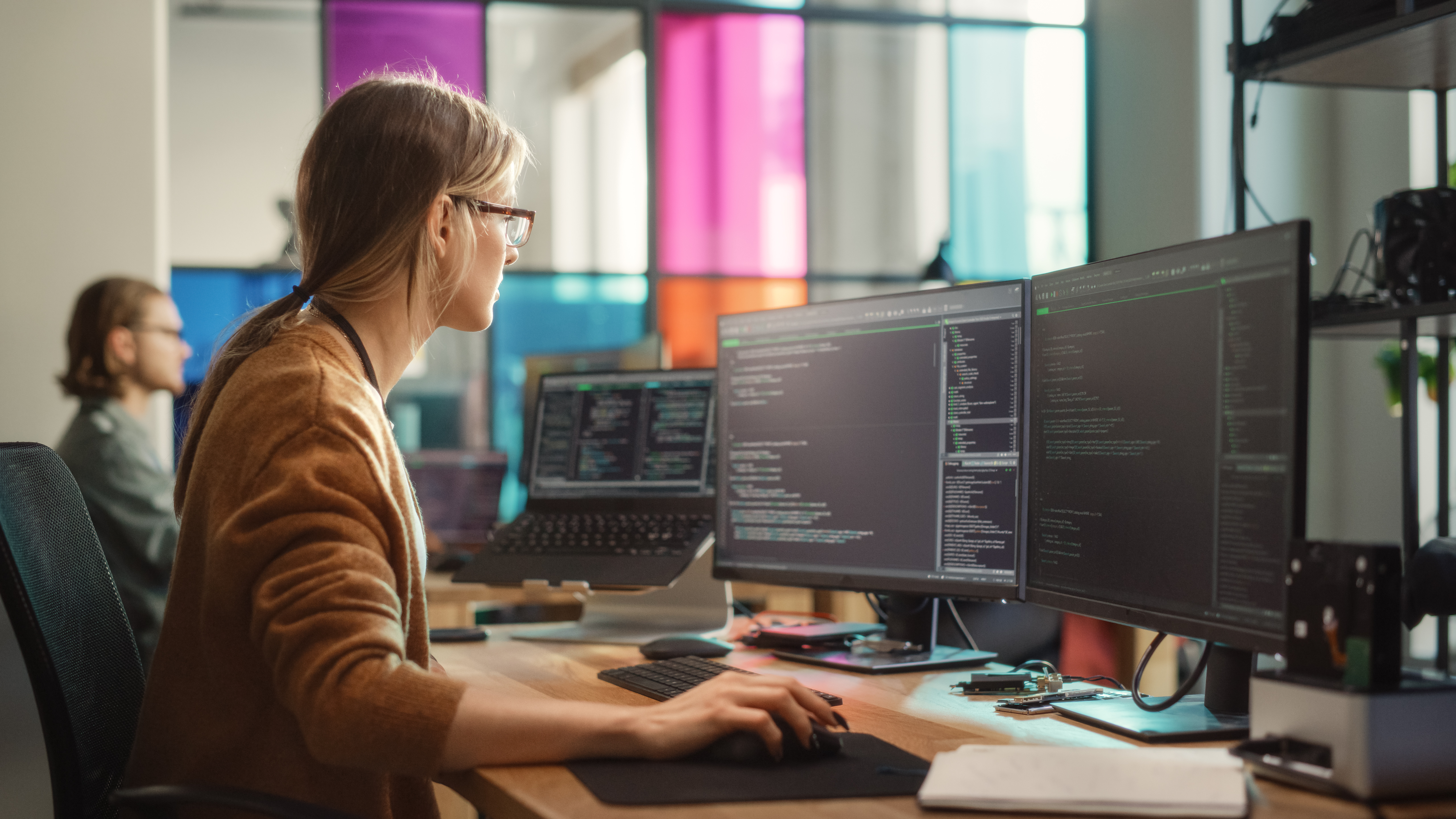 Woman looking at computer screens